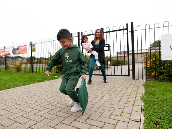 Young boy running to school on a Persimmon homes development