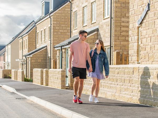 Young couple walking on a Persimmon Homes development