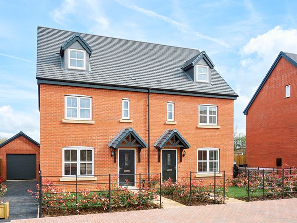 Two semi detached red brick new build houses